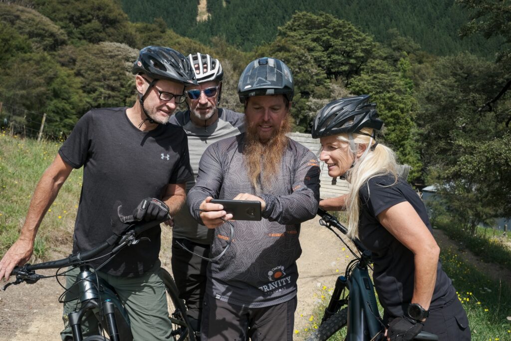 A coach showing mtb clients their riding form in the FlowLab FREE coaching analysis app.