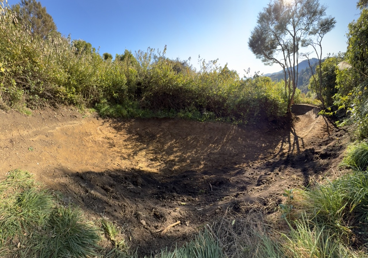 Ridge-line flow berm with coastal views and sculpted clay