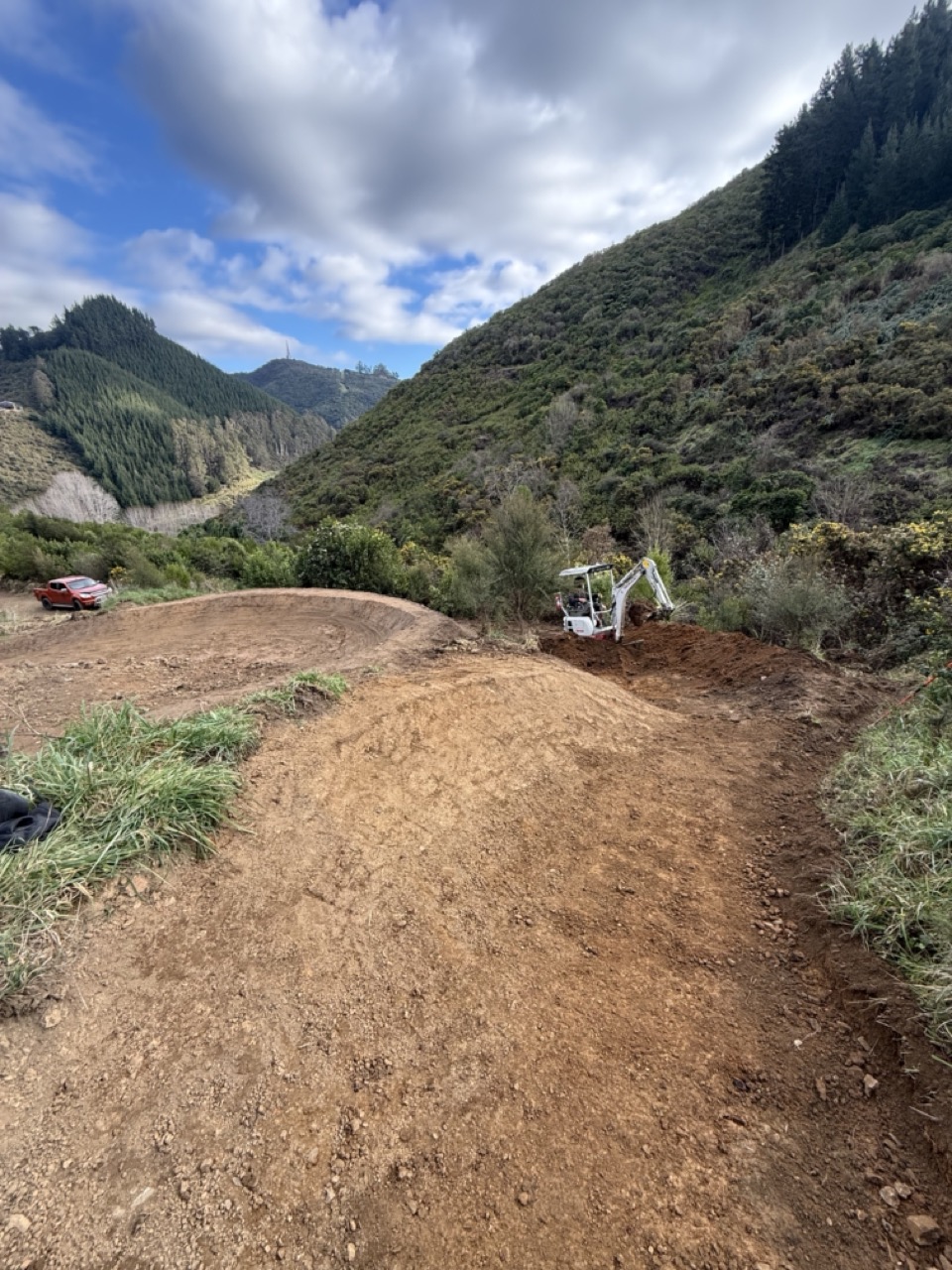 Machine shaping on flow trail with excavator